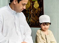 Muslim boy learning how to Salah