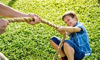 Boy playing tug of war in the park
