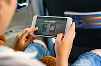 Boy playing on a smartphone in the car