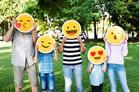 Happy family holding up emojis