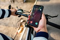 Biker holding smartphone with Incoming call