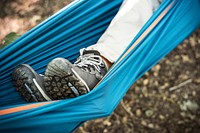 Woman relaxing in a hammock in the forest