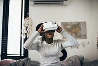 Girl using VR device in her bedroom