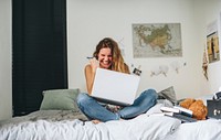 Girl using a laptop gesturing excitement