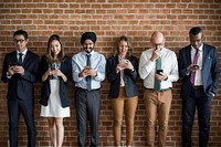 Business people standing and using smartphones