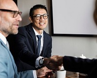 Corporate businessman shaking hands in a meeting