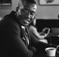 African American businessman in a cafe smiling