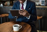 Businessman in a cafe using a tablet