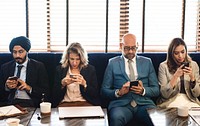 Business people using smartphones in a cafe