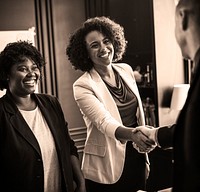 Business person greeted by a handshake