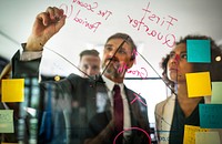 Businesspeople planning on a glass wall
