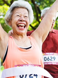 Elderly asian woman reaching the finish line