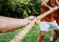 Mature people in tug of war