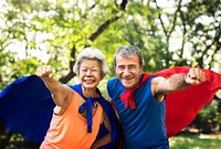 Childlike seniors wearing superhero costumes