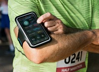 Senior runner using a fitness tracker application