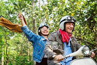 Senior couple riding a classic scooter