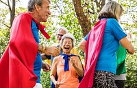 Childlike seniors wearing superhero costumes