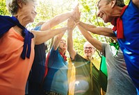 Childlike seniors superheroes giving a high five