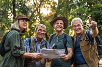 Group of senior trekkers checking a map for direction