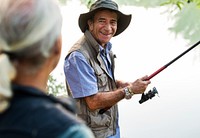 Senior friends fishing by the lake