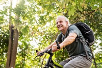 Senior man biking in the park