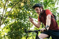 Senior cyclist using gps on mobile phone