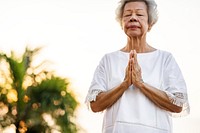 Senior woman practicing yoga in the morning