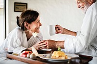 A senior couple enjoying room service