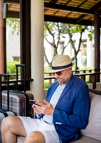 Man using mobile phone at hotel lobby