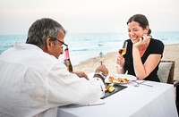 A couple eating dinner on the beach