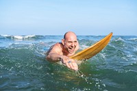 A senior man on a surfboard<br />
