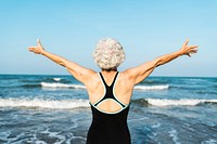 Mature Asian woman stretching out her arms