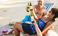 Mature friends having beers at the beach