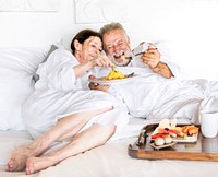A senior couple enjoying some room service