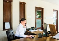 Female resort receptionist working at the front desk