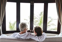 A senior couple sitting on a sofa