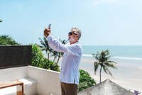Senior man on vacation taking a selfie