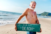 Senior man holding a plank with Sunset Beach