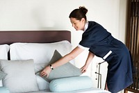 Housekeeper cleaning a hotel room