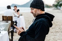 Man using his mobile phone at the beach