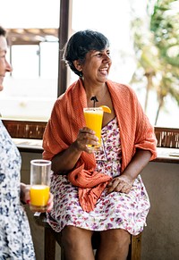 Senior woman drinking orange juice at a resort