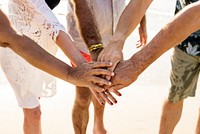 Group of senior friends stacking hands