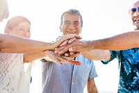 Diverse senior friends hanging out on beach