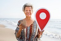 Senior Asian woman checking in at the beach