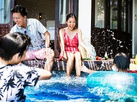 Family playing in a pool