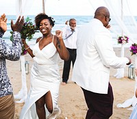 African American couple getting married at the beach