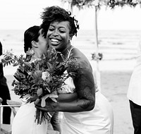 Cheerful bride hugging her friend