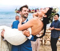 Cheerful newlyweds at beach wedding ceremony