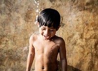 A little boy taking a shower