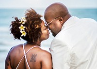 African American couple getting married at the beach